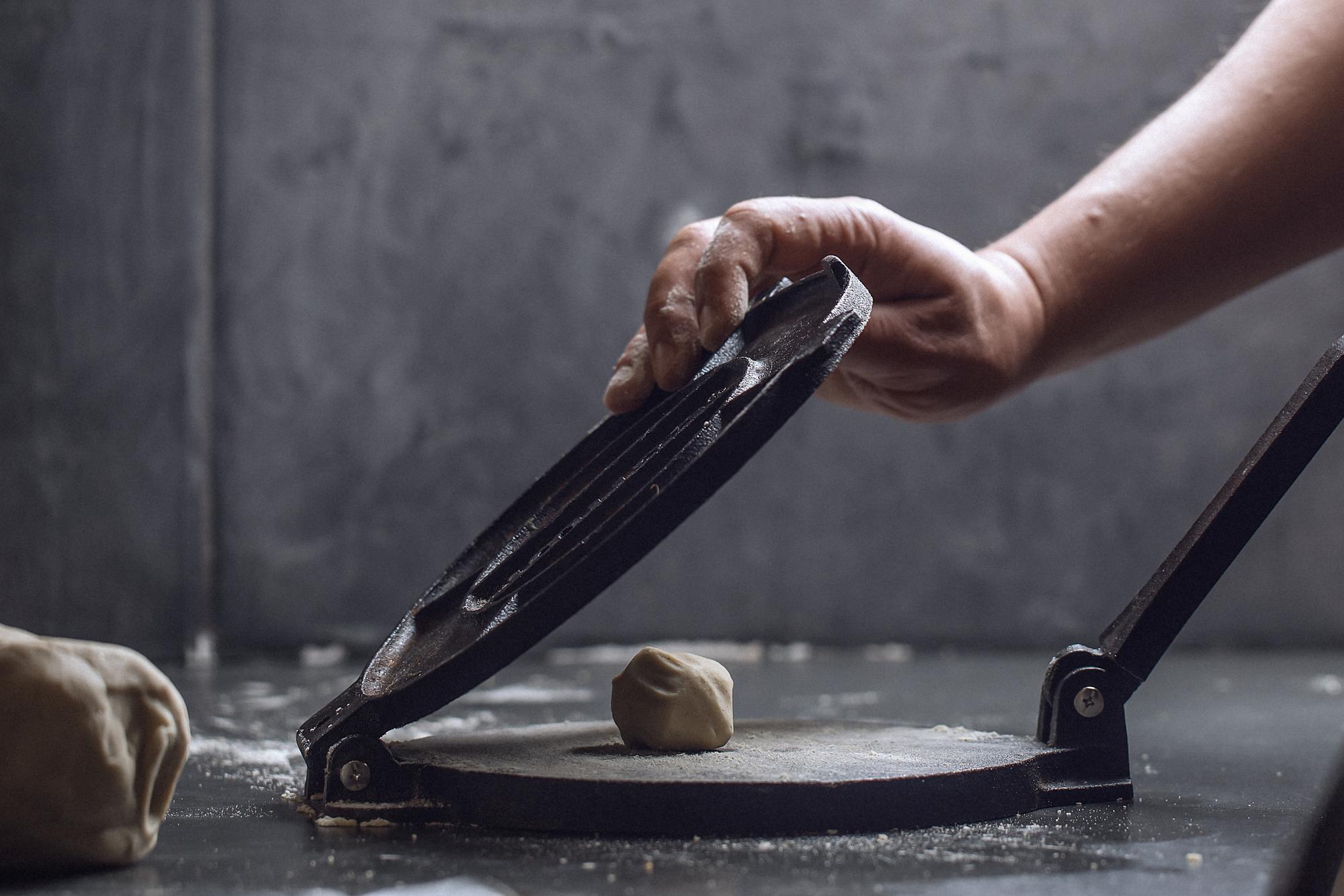 Hands preparing dough with modern tools